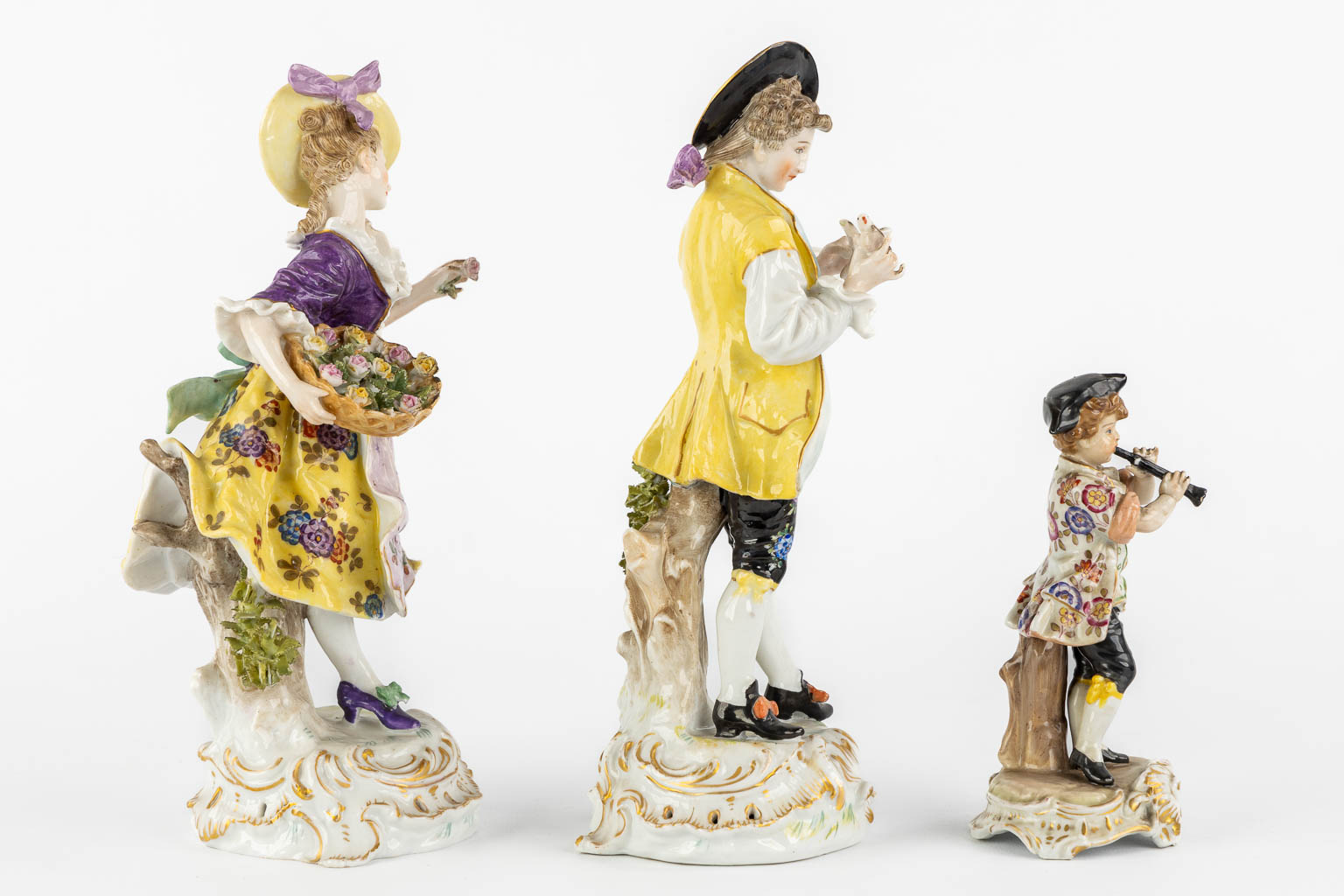 A pair of polychrome porcelain figurines, added A Saxony porcelain boy. (H:23,5 cm)