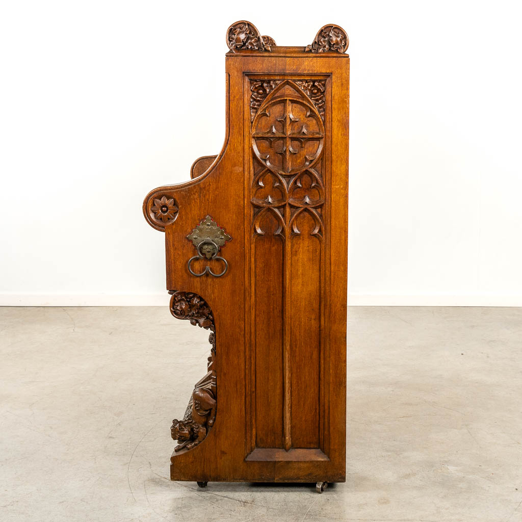 An antique organ, sculptured wood in Gothic Revival style. Circa 1900.